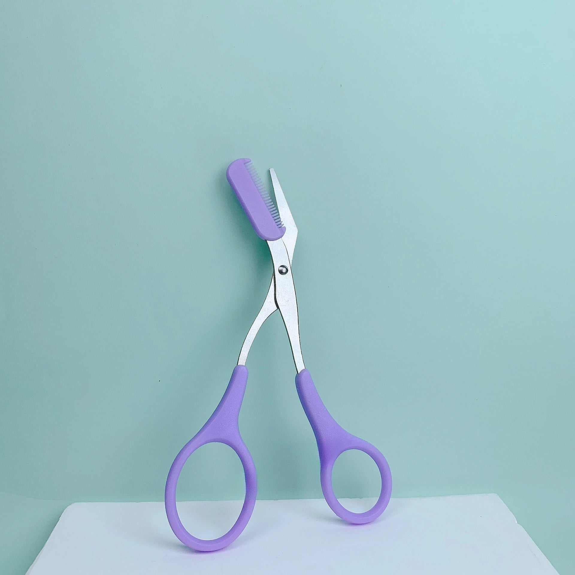 Pink eyebrow trimming scissors with built-in comb - stainless steel, precise grooming tool, creating perfect eyebrows